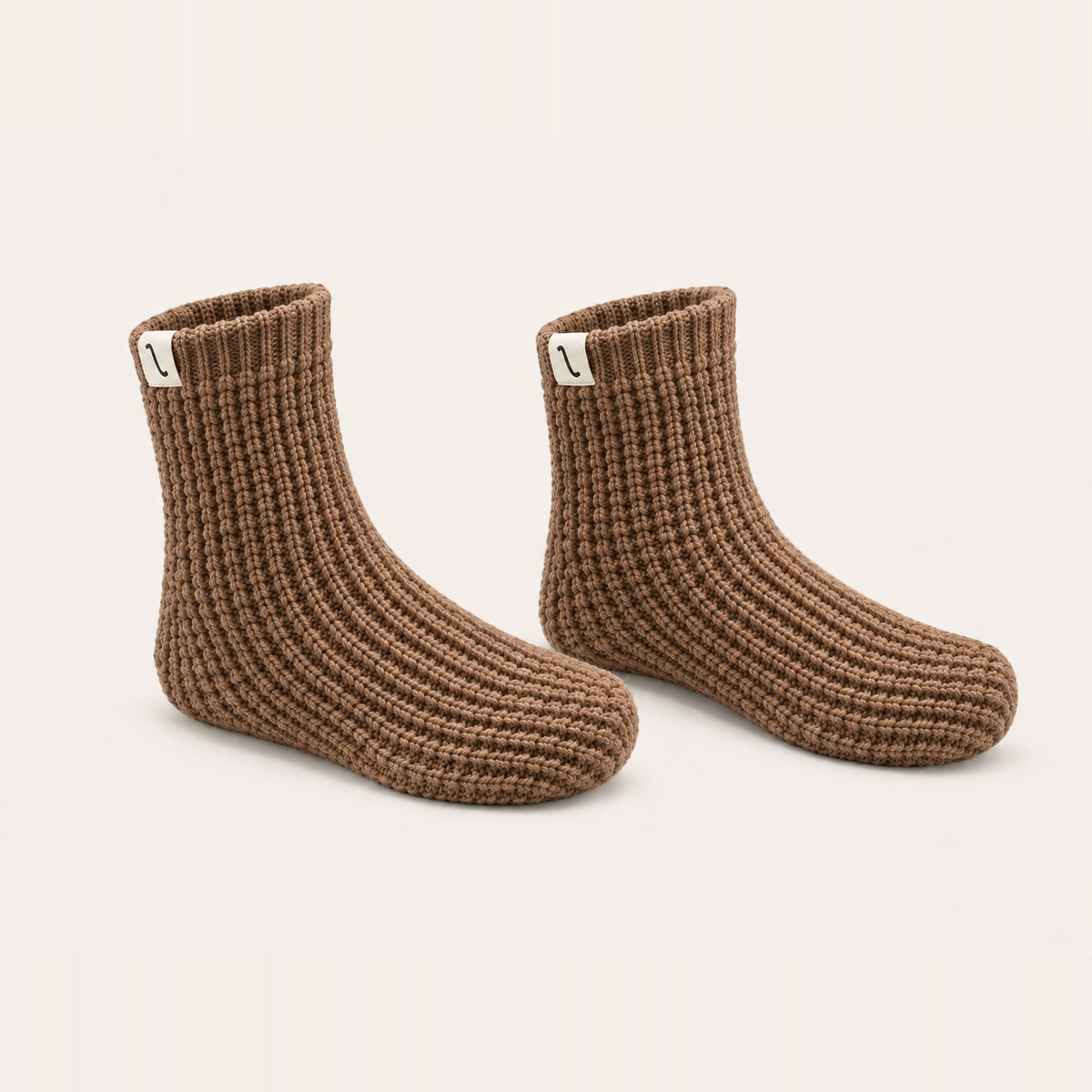 After Tracks merino waffle house socks in Camel, angled pair on a cream background